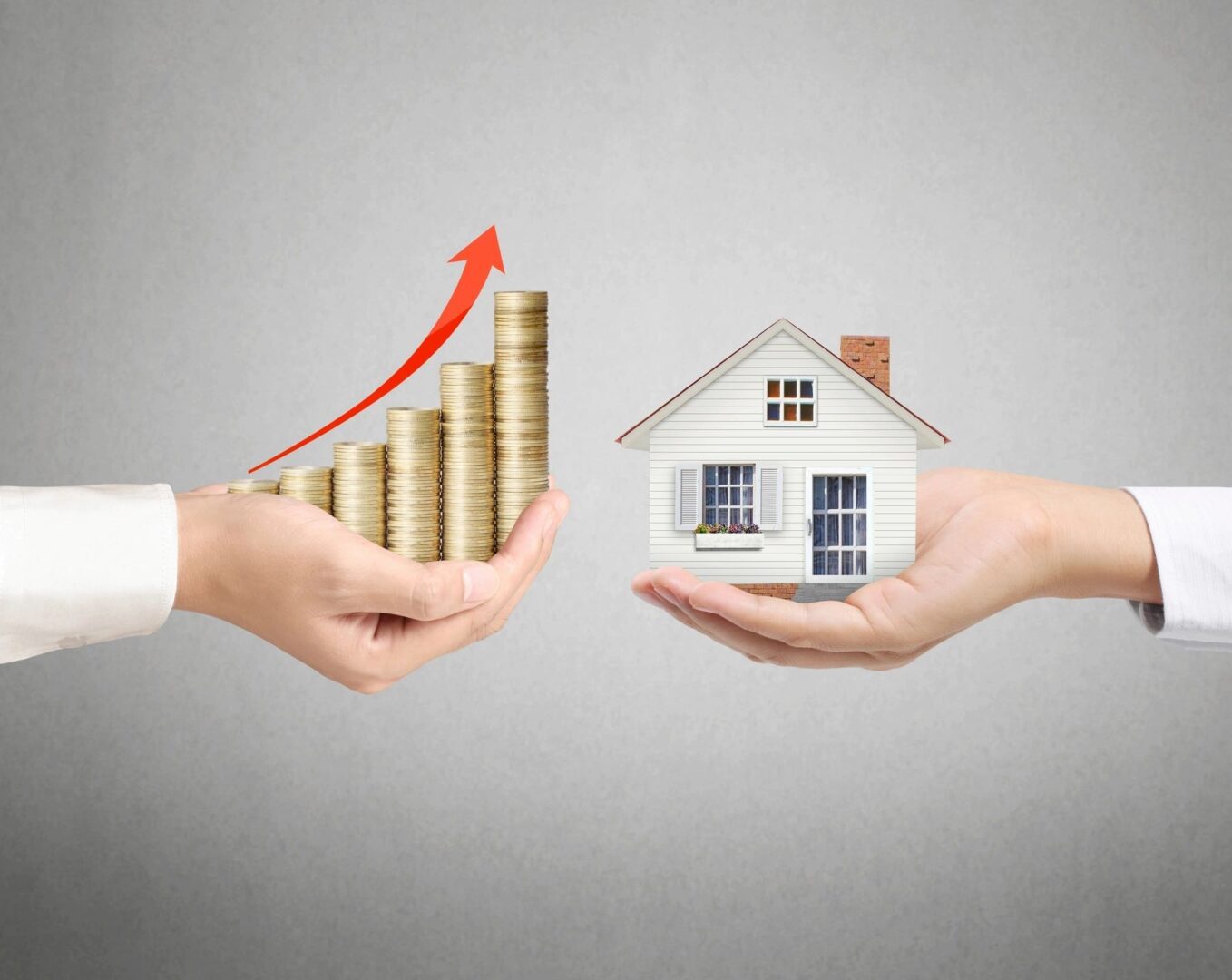 A couple of hands holding up coins and a house.